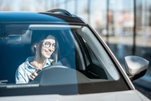 woman looking through car windshield