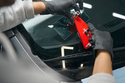auto glass technician fixing crack in adas windshield