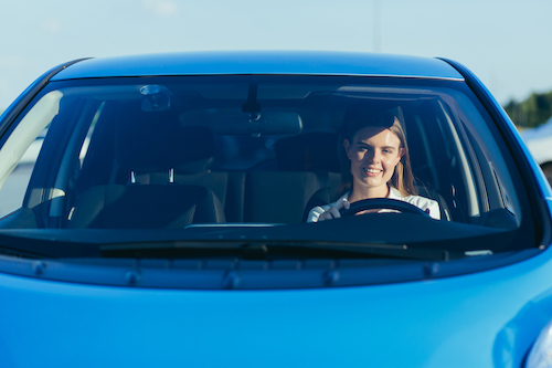 woman driving with a new car windshield