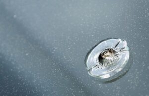 closeup of a chipped windshield in need of repair