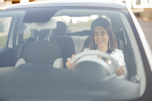 woman happily driving after a windshield calibration