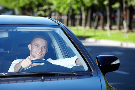 man happily driving after a windshield calibration service