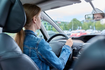 young woman driving after a windshield repair
